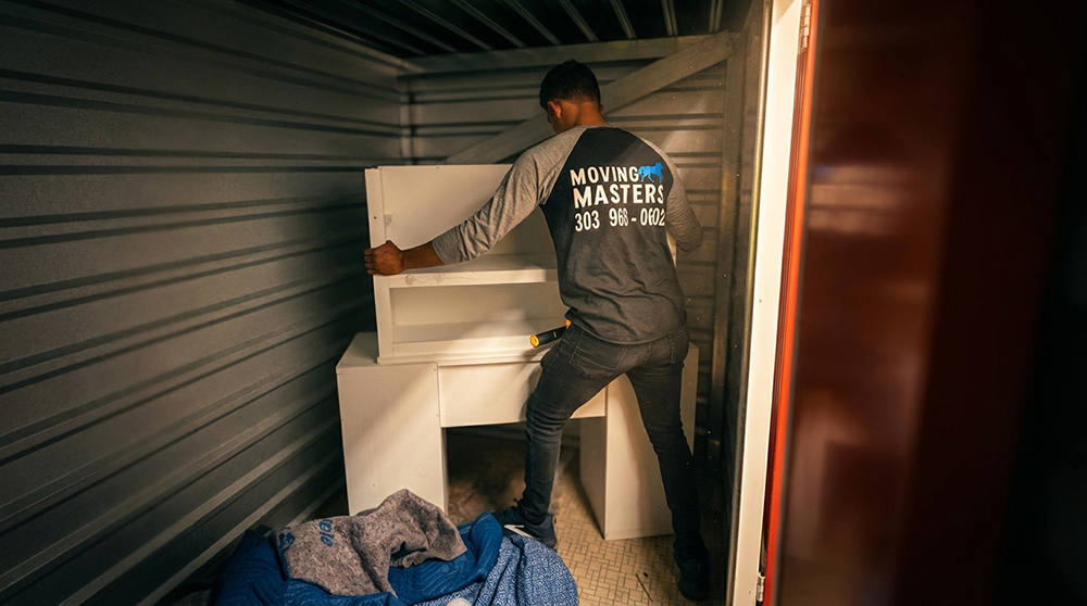 Mover organizing furniture inside a storage unit